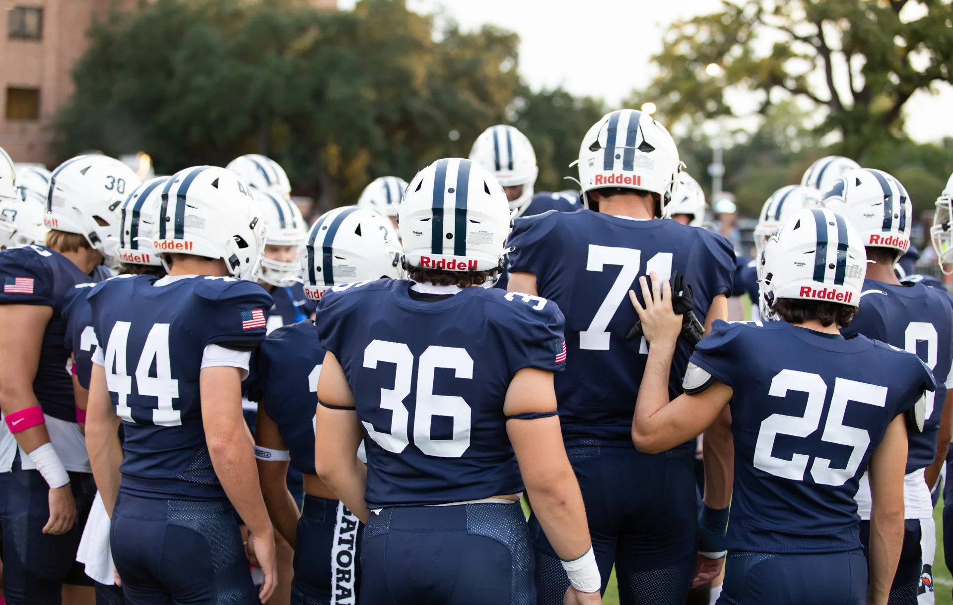 group of young football players in a huddle